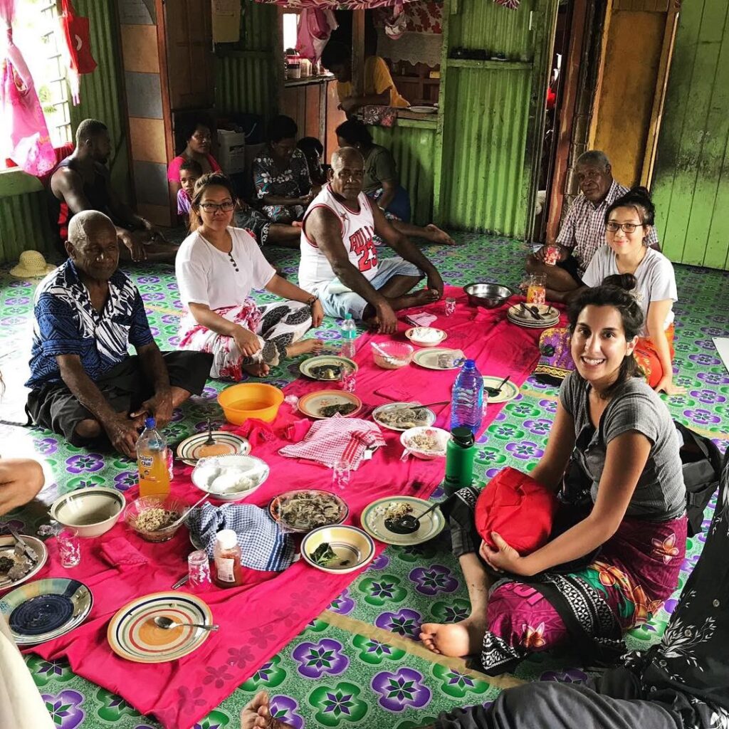 Volunteer-in-fiji-sitting-with-villagers-having-talk-about-nutrition VolunteerForever